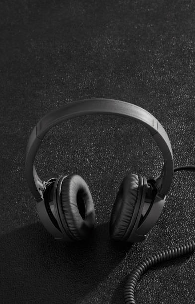 istock Black headphones on desk 1197887043