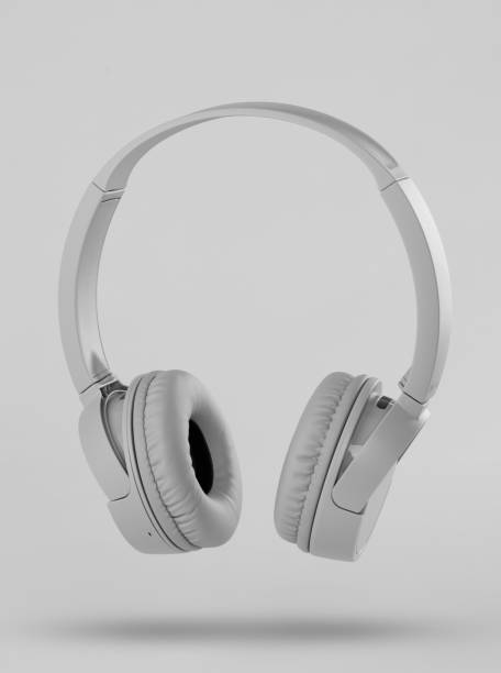 istock Gray wireless headphones on gray background 1197887048