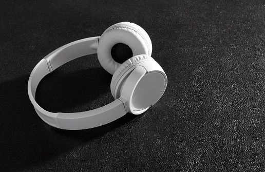 Gray wireless headphones on black background