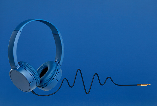 Headphones with pulse cable on blue background