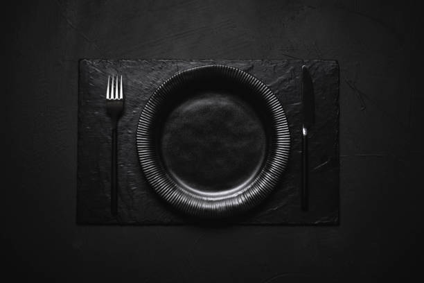 istock Empty black dish and cutlery on black table. Black table arrangement 1197887528
