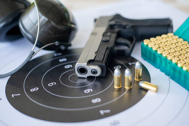 istock Guns with ammunition on paper target shooting   practice 1197888720