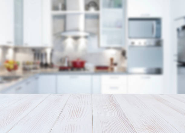Empty kitchen countertop Empty kitchen countertop with defocused modern kitchen background. Highly suitable for product montage kitchen stock pictures, royalty-free photos & images