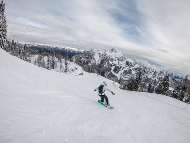Woman snowboarding in Ski Resort, Austria, Nassfeld. GoPro.