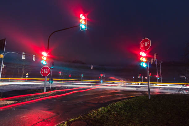 istock traffic lights and wet road at night 1197889651