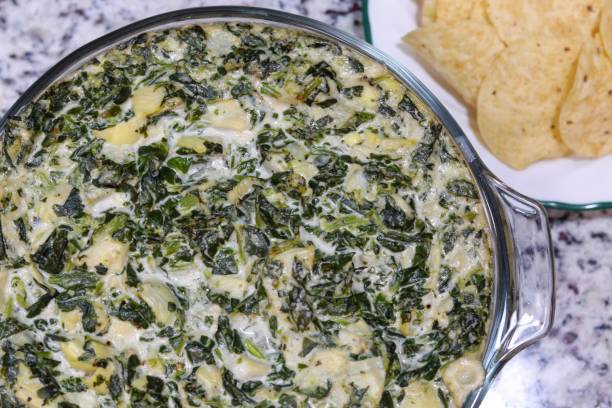 Spinach and Artichoke Dip Spinach and Artichoke Dip with chips dipping sauce stock pictures, royalty-free photos & images