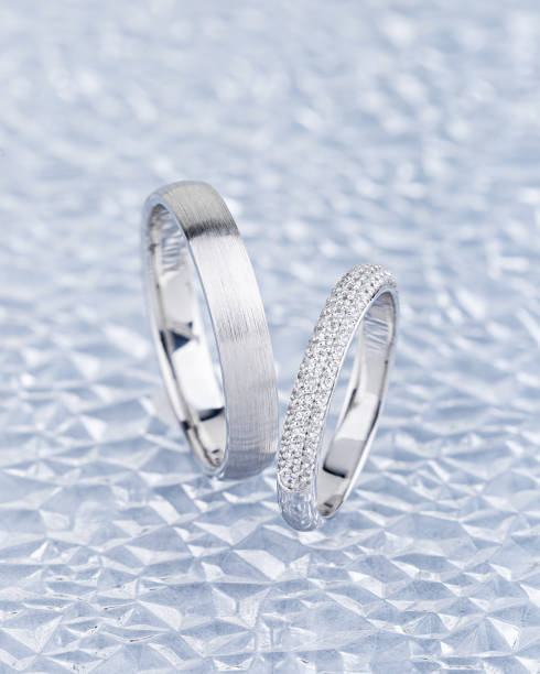 istock Pair of silver wedding rings on gray background 1197891070