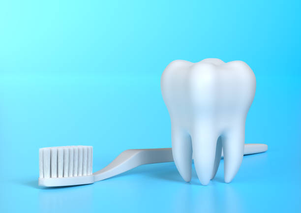 istock Toothbrush and white tooth on a blue background 1197892120