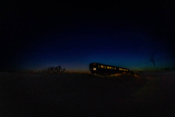 istock Train travelling at speed by moonlight 1197894024