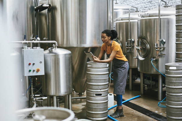 Mixed Race Female Craft Brewer Using Digital Tablet
