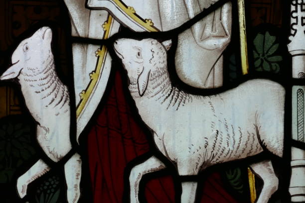 The Lamb of God This ancient stained glass window shows the Bible stories agnus dei stock pictures, royalty-free photos & images