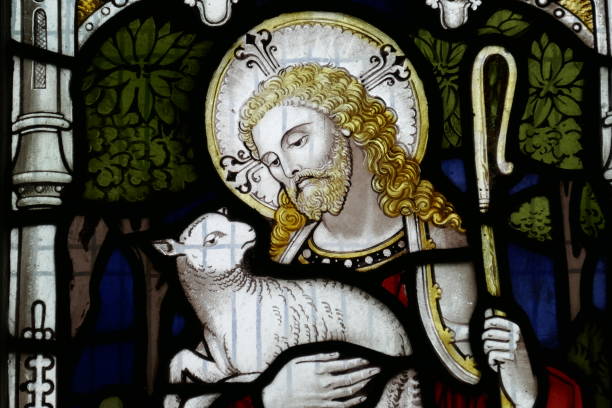 The Lamb of God This ancient stained glass window shows the Bible stories agnus dei stock pictures, royalty-free photos & images