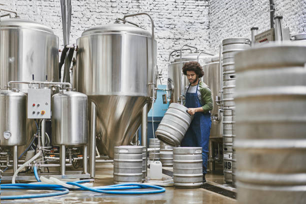 istock Young Native American Brewery Worker Stacking Beer Kegs 1197895347