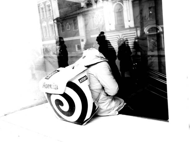 Moscow, Russia - January 06, 2020: food delivery person is sitting at the subway station behind the window