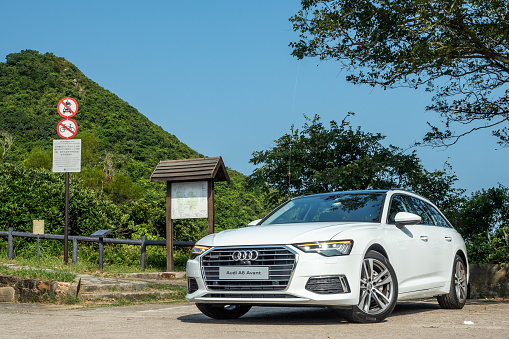 Kempten, Allgäu, Schwaben, Bavaria, Germany, may 1st 2022, a black German Audi Q3 Sportback approaching on the German A7 Autobahn at Kempten - in the background on the other side of the road is a parking lot with some trucks - with a length of 963 km between the borders of Denmark in the north and Austria in the south, the Autobahn 7 is the longest Autobahn in Germany