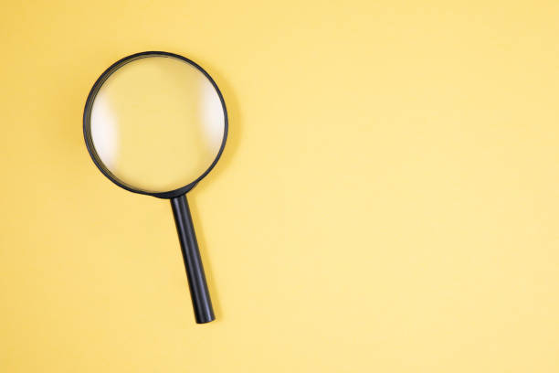 istock Magnifying Glass on Yellow Background 1197899918