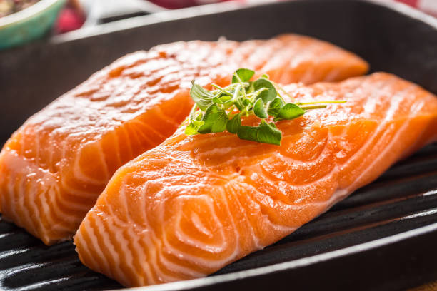 istock Fresh raw salmon fillets served in cast iron grill pan 1197900536