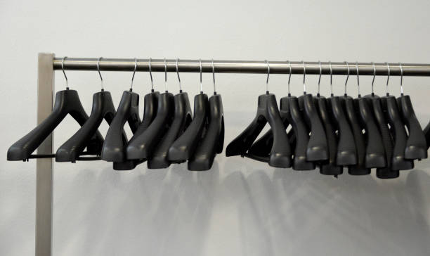 Black plastic hangers hangs on the metal stand Black plastic hangers hangs on the stand, on the hotels reception indoors restaurant hotel work tool stock pictures, royalty-free photos & images