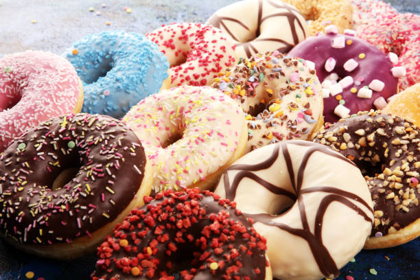 istock assorted donuts with chocolate frosted, pink glazed and sprinkles donuts 1197906848