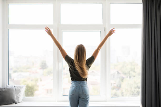 istock Young woman stretching in bed after waking up, back view 1197906925