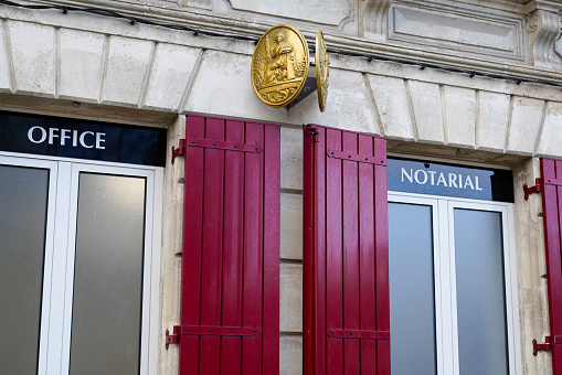 Notaire french sign gold on wall above entrance to the notary office