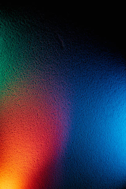istock Blue, orange and light green glow on a black background 1197907674