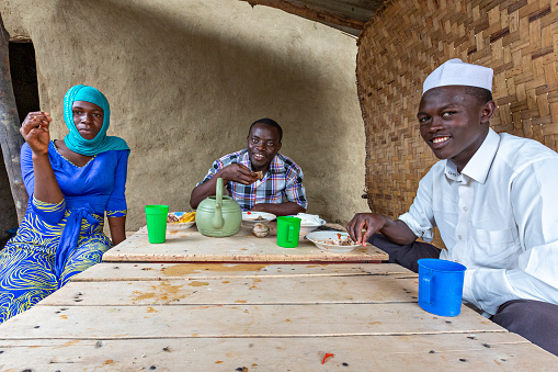 Lake George, Uganda - July 12, 2019: Local people eating, Lake George, Uganda