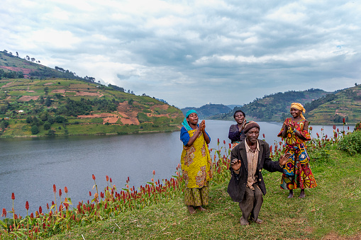 Lake Bunyonyi, Uganda - July 14, 2019: Batwa tribal people known also as Pygmies, dance and sing, at the Lake Bunyonyi, Uganda