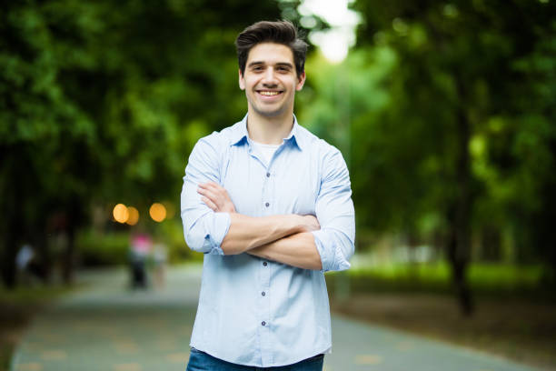 istock Thoughtful casual young man outdoors looking up and smiling 1197913268