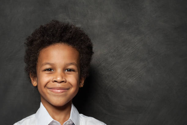istock Happy child boy face on blackboard background 1197913294