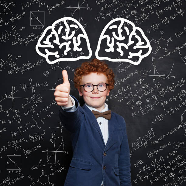 istock Happy child boy smiling and showing thumb up on science background 1197913407
