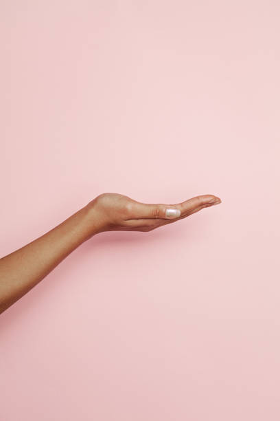 Empty woman hand on pink background. Woman hand presenting Empty woman hand on pink background. Woman hand presenting palm of hand stock pictures, royalty-free photos & images