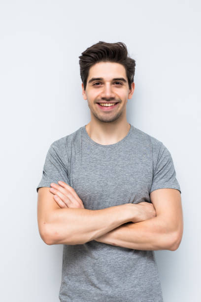 istock Serious man with arms folded standing isolated on a white background 1197918417