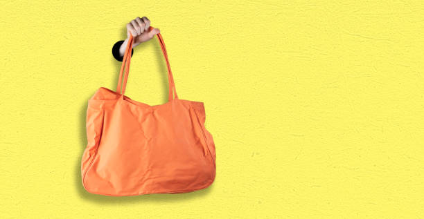 istock hand holding a blank monocolor textile cotton bag with copy space, design for text 1197919110