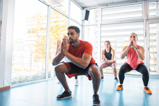 istock Small group of people doing burpee exercise in the gym 1197919358