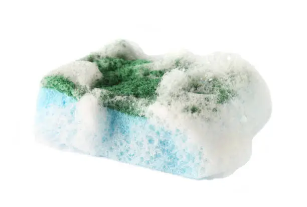 Photo of foamy dishwashing sponge isolated onwhite background, selective focus