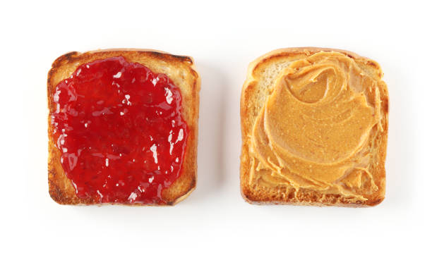 istock toasted bread with peanut butter and jam isolated on white background, top view 1197919593