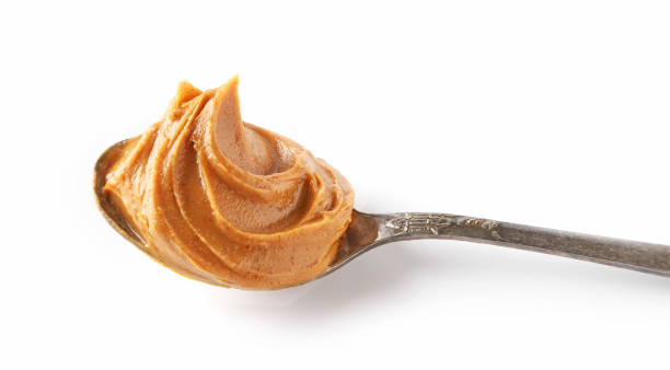 istock spoon of peanut butter isolated on white background 1197919605
