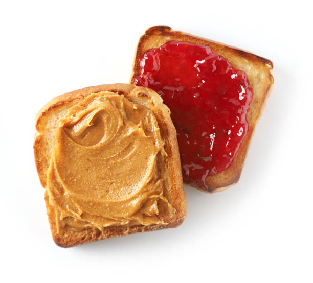 istock toasted bread with peanut butter and jam isolated on white background, top view 1197919614