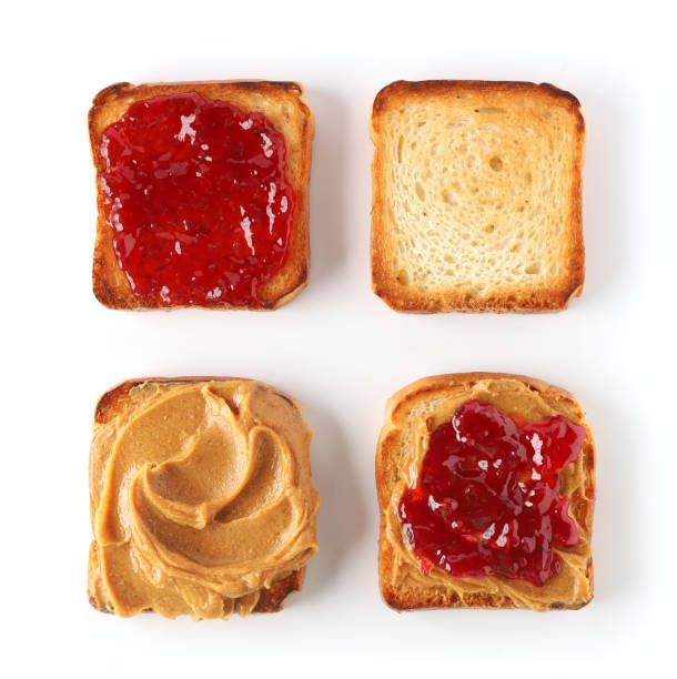 istock toasted bread with peanut butter and jam isolated on white background, top view 1197919617