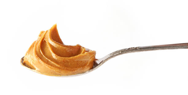 istock spoon of peanut butter isolated on white background 1197919621
