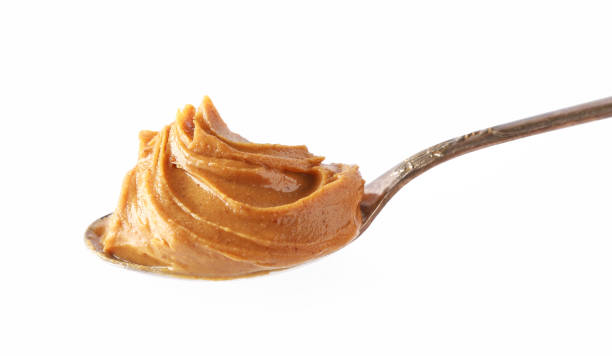 istock spoon of peanut butter isolated on white background 1197919625