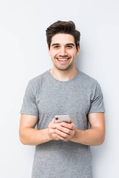 istock Handsome young man using his smartphone isolated on white background 1197920534