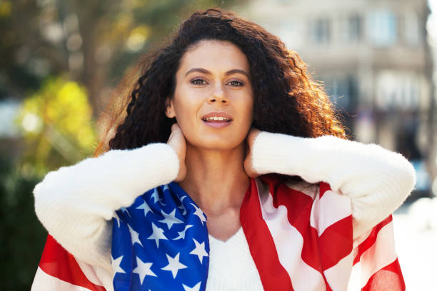 istock Young woman with the American flag 1197920773
