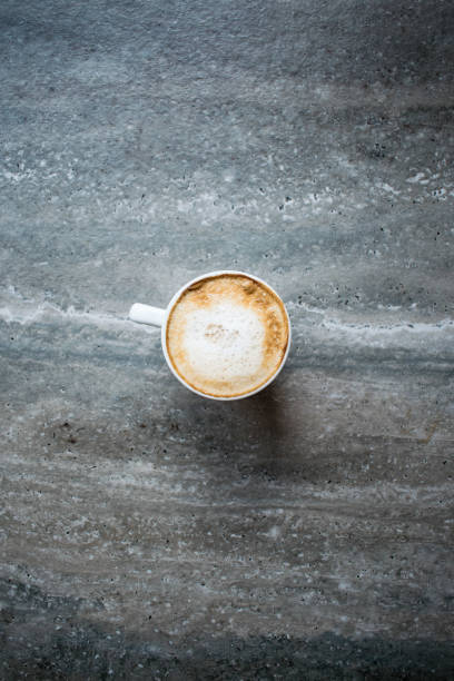 istock Late coffee with soya milk in white cup from top view on the grey table 1197921675