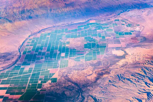 Aerial view of agricultural fields on the Colorado River valley in Arizona, at the border with California; the City of Parker visible in the right upper corner