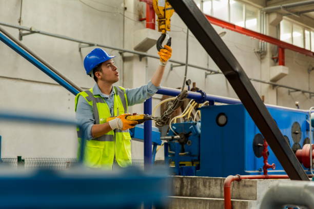 istock Young businessman holding and working with remote control for operating crane 1197927931