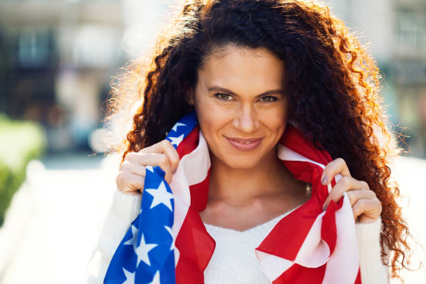 istock Young woman with the American flag 1197929607