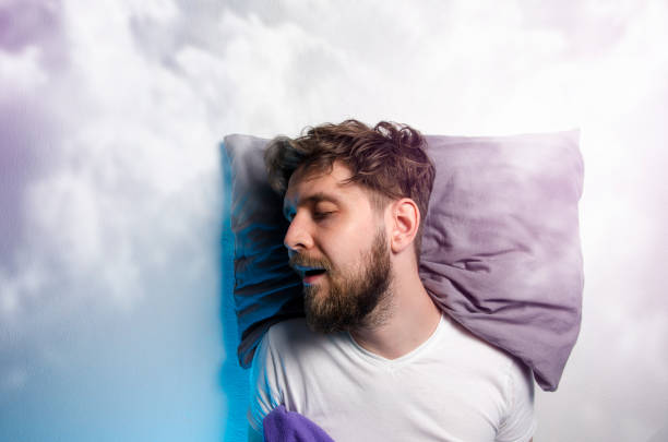 istock Man sound asleep , enjoying his nap , sleeping in clouds 1197929610