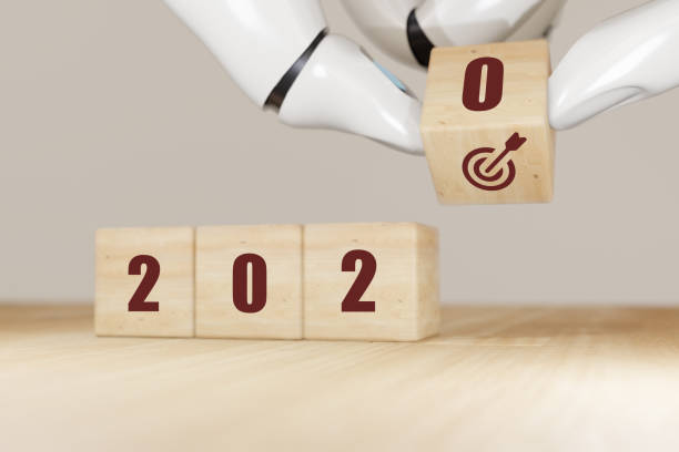 istock 3d rendering artificial intelligence robot hand flip the 2020 wooden to target dart cube concept to make growth in business in year 2020 1197931218